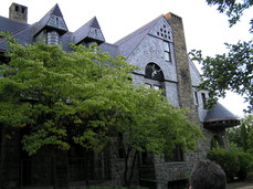 [German style house with a big shield and rock wall]